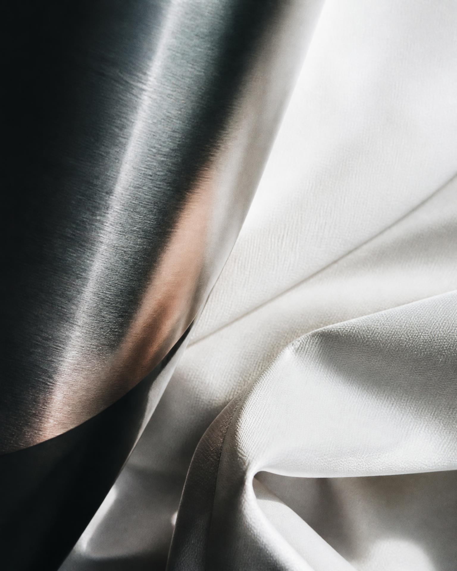 Brushed steel meeting draped technical fabric