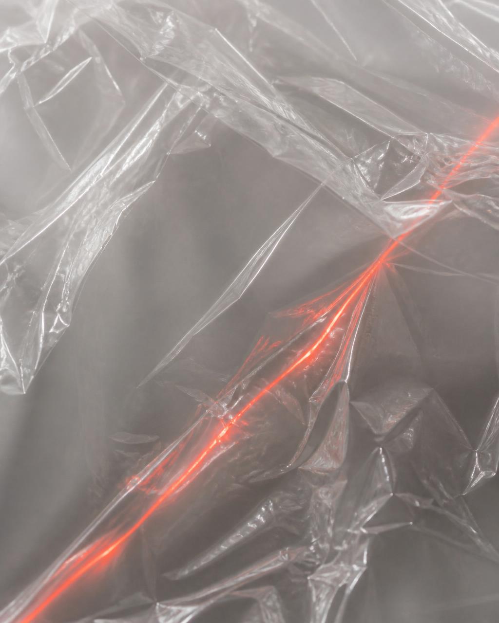 Industrial film texture cut by a single red signal line